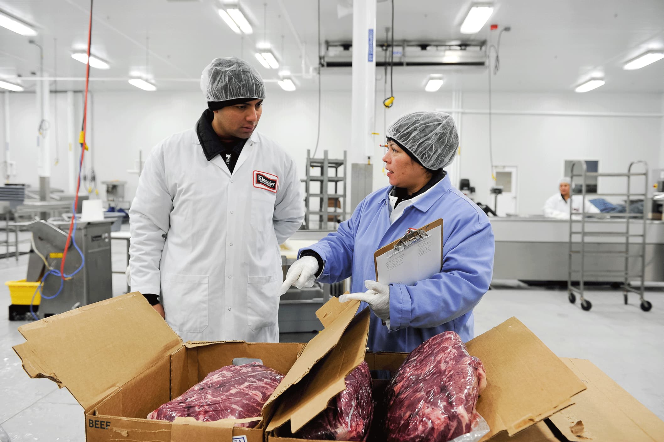 A man and a woman are working in a factory.